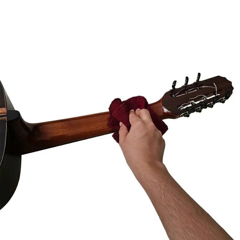 pessoa limpando o braço de um violão de sete cordas